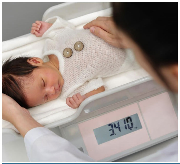 Scales for babies showing a tared blanket on an infant tray with weight displayed clearly.